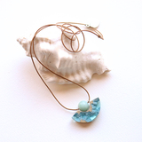 Reef curved beach necklace on white background with shell