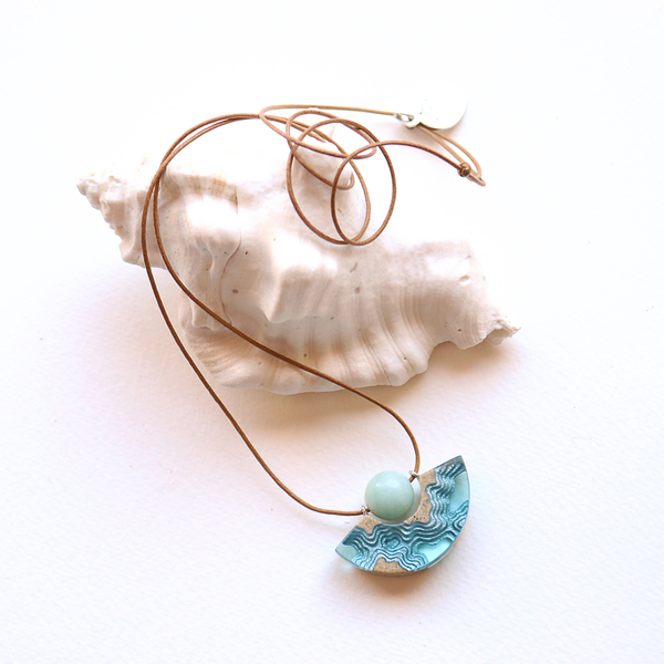 Reef curved beach necklace on white background with shell