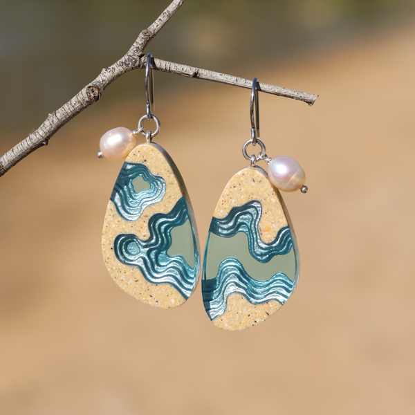 Rockpool large beach sand and blue resin dangle earrings on beach